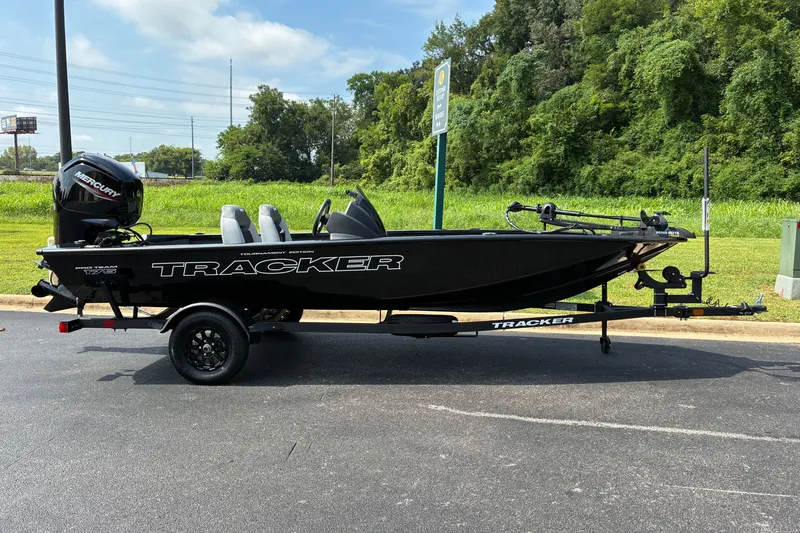 The Image of 2027 Tracker Pro Team 175 boat on trailer, parked outdoors. - 0