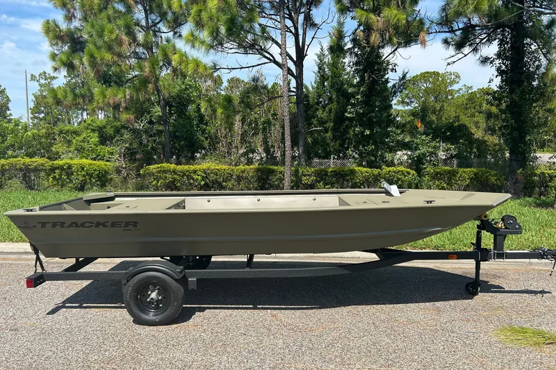 The Image of 2027 Tracker Grizzly 1648 Utility boat on trailer, parked outdoors. - 0