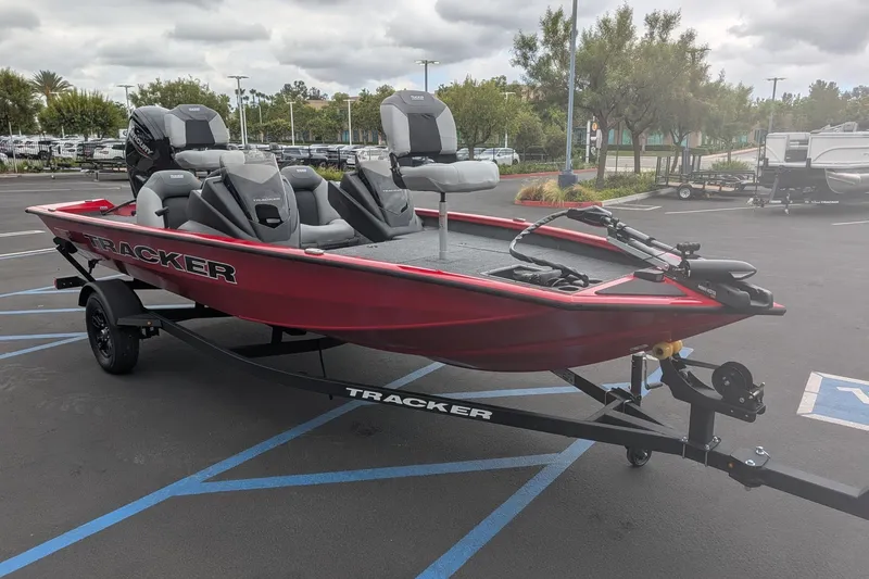 The Image of 2027 Tracker Pro Team 175 boat on trailer in parking lot. - 0