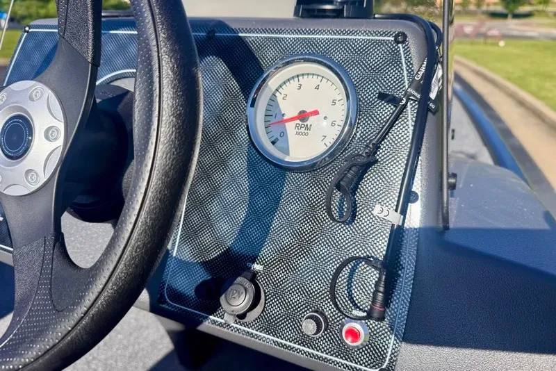 Slide: The Image of Dashboard of 2027 Tracker Bass Tracker Classic XL with RPM gauge and steering wheel. - 14
