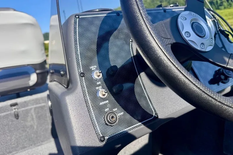 Slide: The Image of 2027 Tracker Bass Tracker Classic XL dashboard with steering wheel and control panel. - 15