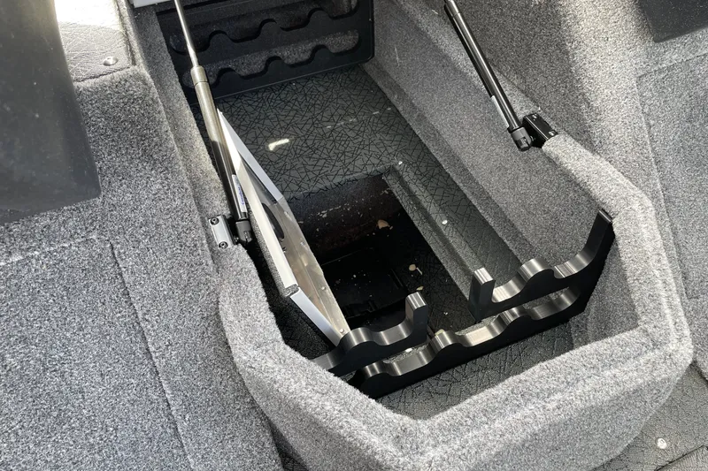 Slide: The Image of 2027 Tracker Pro Guide V-175 Combo boat interior storage compartment with rod holders. - 24