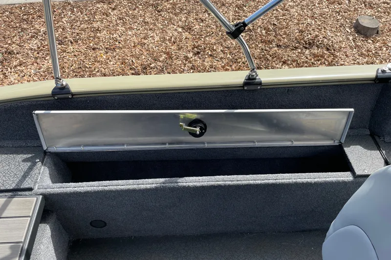 Slide: The Image of 2027 Tracker Pro Guide V-175 Combo boat storage compartment open, showcasing interior space. - 16