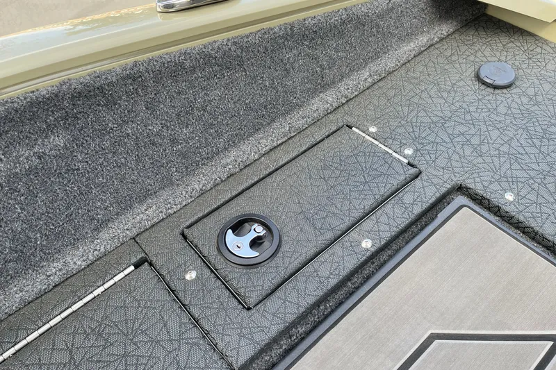 Slide: The Image of 2027 Tracker Pro Guide V-175 Combo boat deck with storage compartment and textured surface. - 13
