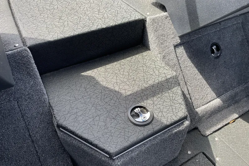 Slide: The Image of Interior of 2027 Tracker Pro Guide V-175 Combo boat, featuring carpeted storage compartments. - 22