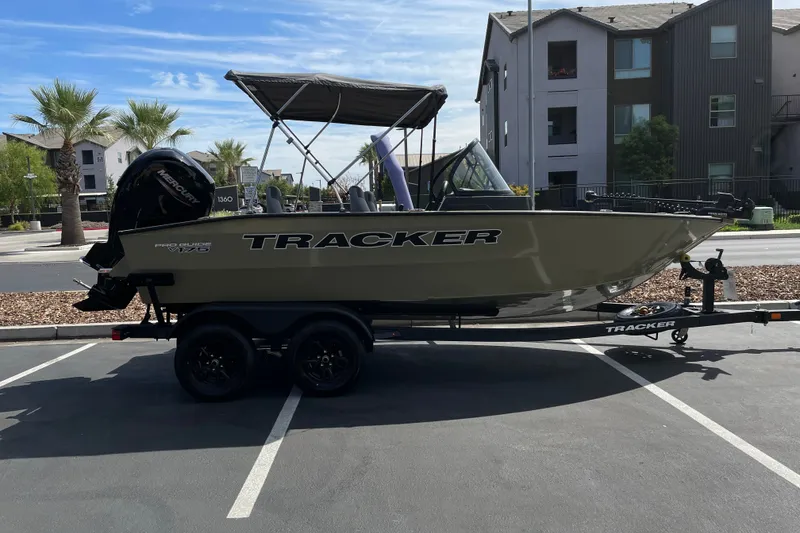 The Image of 2027 Tracker Pro Guide V-175 Combo boat on trailer in parking lot. - 0