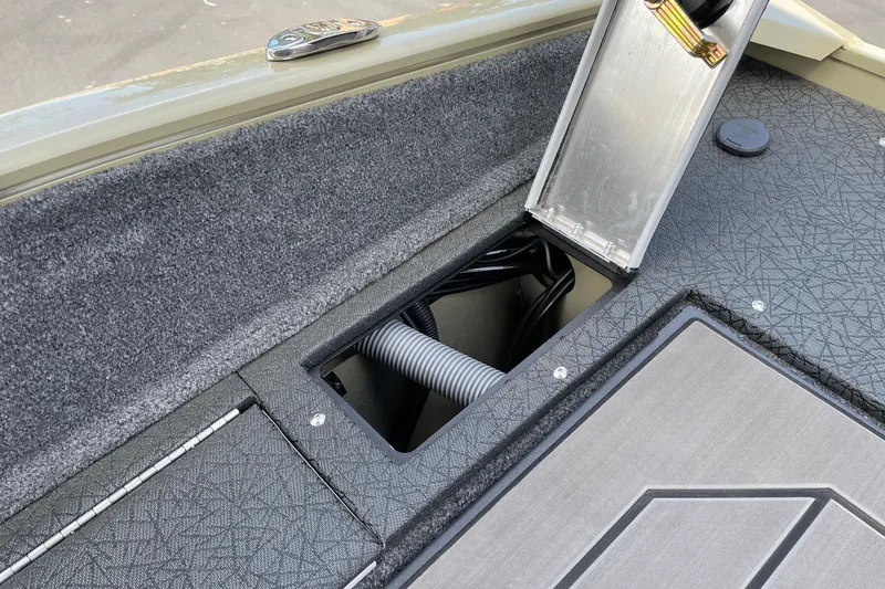 Slide: The Image of 2027 Tracker Pro Guide V-175 Combo boat interior storage compartment with open hatch. - 14