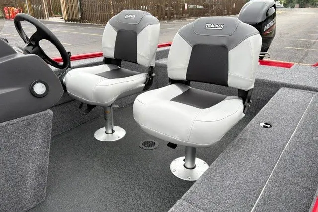 Slide: The Image of 2027 Tracker Super Guide V-16 SC boat interior with two cushioned seats and steering console. - 19
