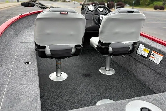 Slide: The Image of 2027 Tracker Super Guide V-16 SC boat interior with dual seats and dashboard view. - 20