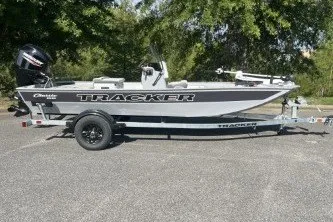 The Image of 2027 Tracker Bass Tracker Classic CC boat on trailer, parked outdoors. - 0