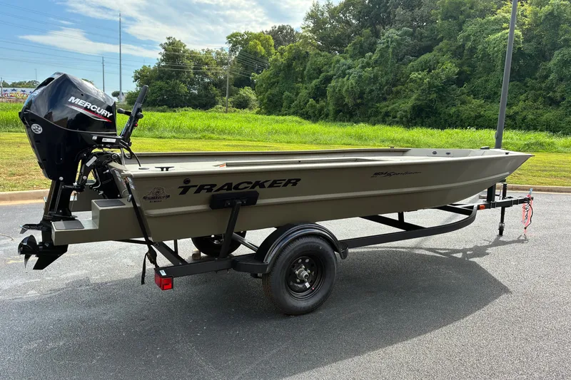The Image of 2027 Tracker Grizzly 1654 T Sportsman boat on trailer, parked outdoors. - 0
