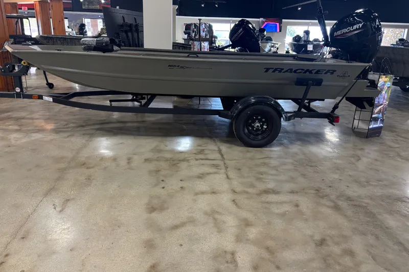 The Image of 2027 Tracker Grizzly 1654 T Sportsman boat on display in showroom. - 1