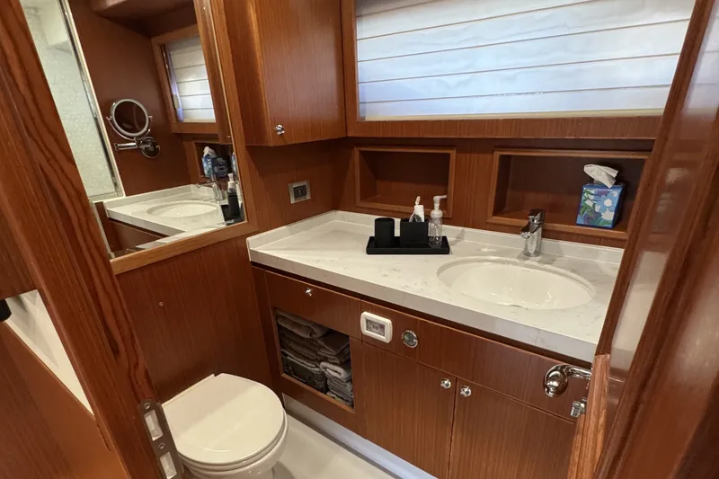 Slide: The Image of Luxurious bathroom in 2023 Apollonian Yachts 52 Pilothouse, featuring wood cabinetry and modern fixtures. - 17