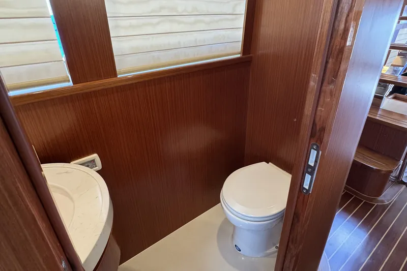 Slide: The Image of Luxurious bathroom in 2023 Apollonian Yachts 52 Pilothouse, featuring wood paneling and modern fixtures. - 11