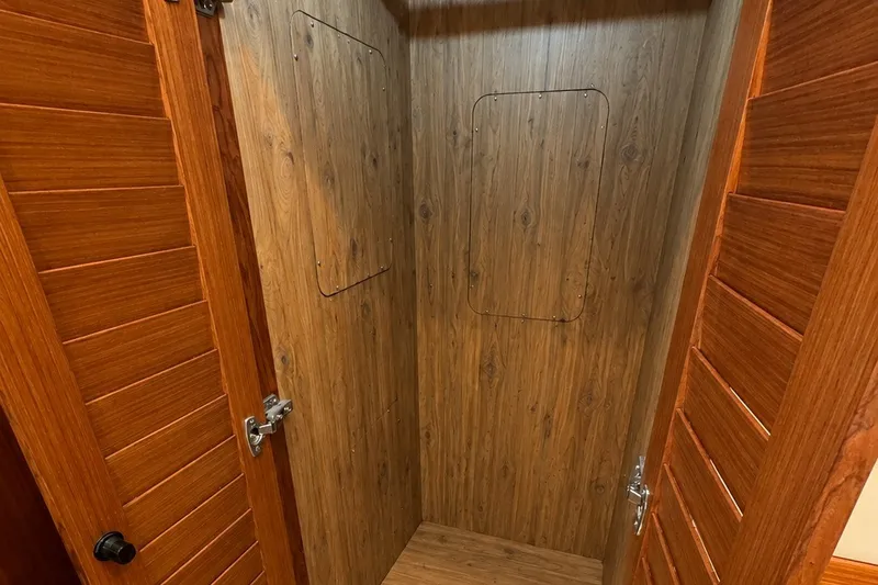 Slide: The Image of Wood-paneled interior of 2023 Apollonian Yachts 52 Pilothouse, featuring elegant wooden doors. - 21