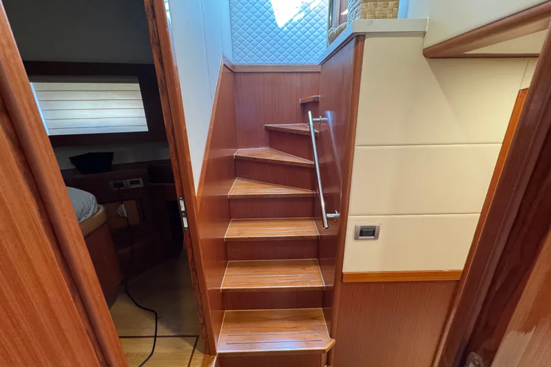 Slide: The Image of Interior staircase of 2023 Apollonian Yachts 52 Pilothouse, featuring wooden steps and modern design. - 26