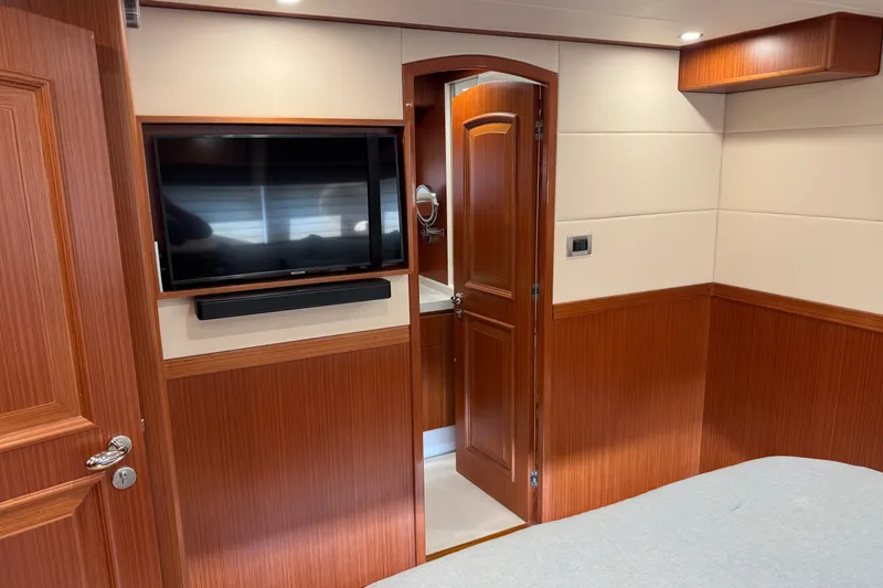 Slide: The Image of Luxurious interior of 2023 Apollonian Yachts 52 Pilothouse with TV and wood paneling. - 16