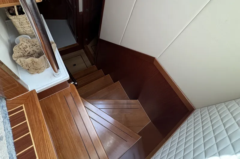 Slide: The Image of Interior staircase of 2023 Apollonian Yachts 52 Pilothouse, featuring elegant wood finish. - 12