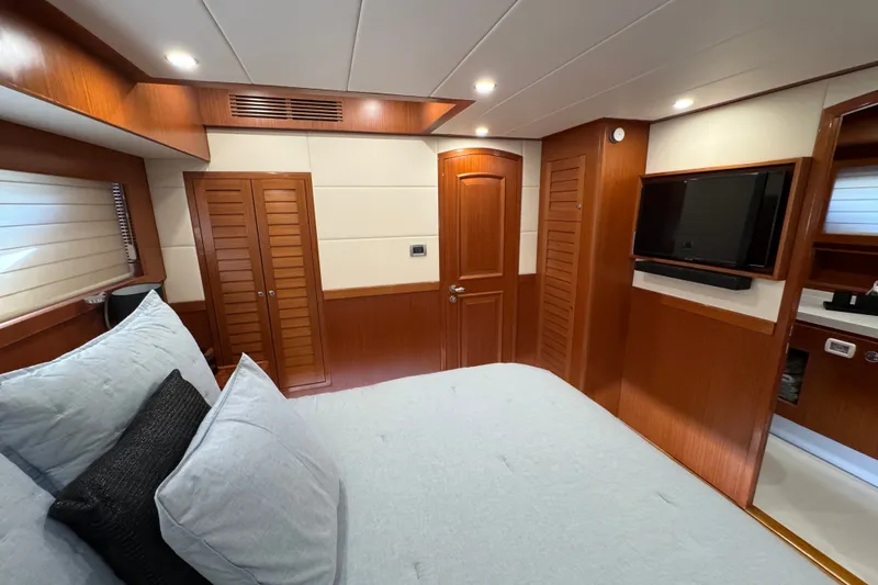 Slide: The Image of Luxurious cabin interior of 2023 Apollonian Yachts 52 Pilothouse, featuring wood paneling and modern amenities. - 19