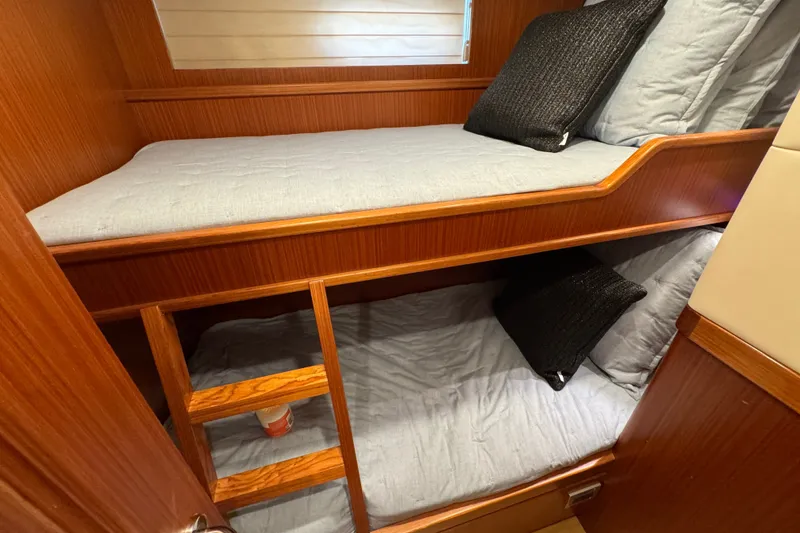 Slide: The Image of Bunk beds in 2023 Apollonian Yachts 52 Pilothouse cabin with wooden finish. - 23