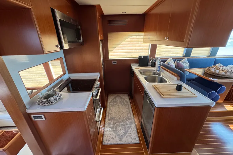 Slide: The Image of Modern kitchen interior of 2023 Apollonian Yachts 52 Pilothouse, featuring sleek wood cabinetry. - 8