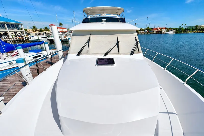 Slide: The Image of 2023 Apollonian Yachts 52 Pilothouse docked at marina under clear blue sky. - 3
