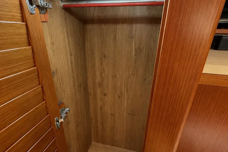 Slide: The Image of Wooden closet interior on 2023 Apollonian Yachts 52 Pilothouse, featuring sleek design and craftsmanship. - 20