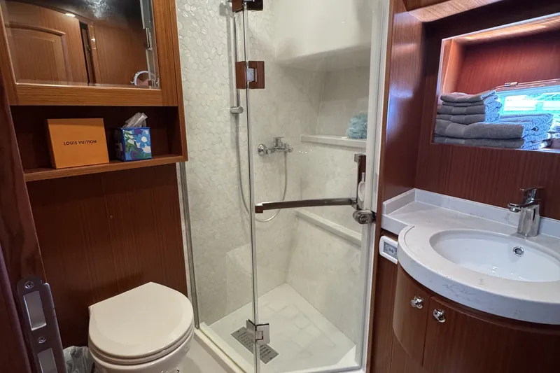 Slide: The Image of Luxurious bathroom in 2023 Apollonian Yachts 52 Pilothouse, featuring elegant wood finishes and modern amenities. - 25