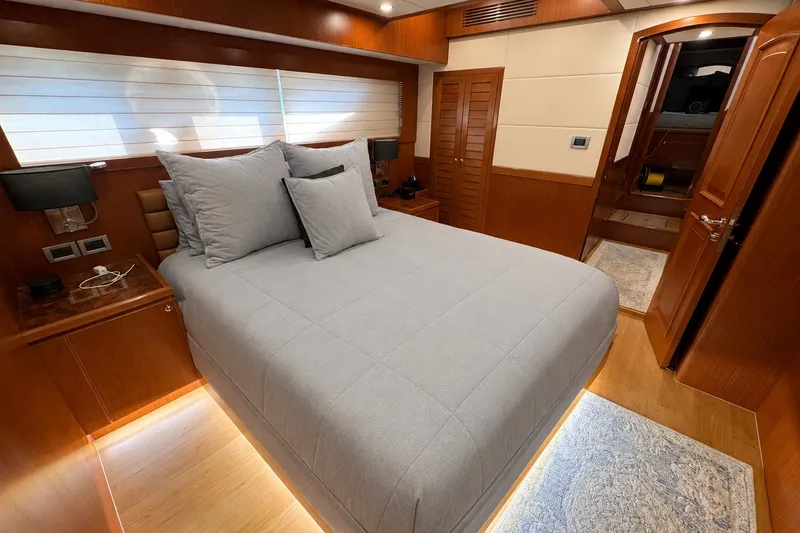 Slide: The Image of Luxurious bedroom interior of 2023 Apollonian Yachts 52 Pilothouse, featuring elegant wood finishes. - 14
