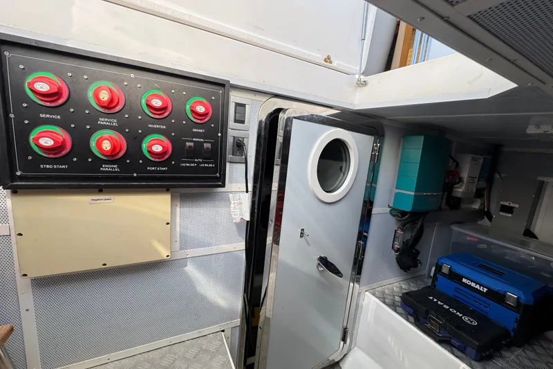 Slide: The Image of Engine room of 2023 Apollonian Yachts 52 Pilothouse with control panel and equipment. - 48