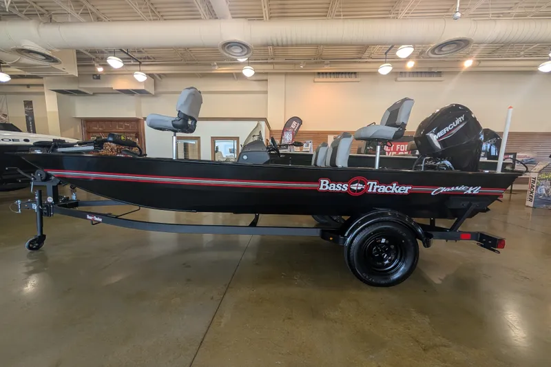 The Image of 2027 Tracker Bass Tracker Classic XL boat displayed indoors on a trailer. - 0