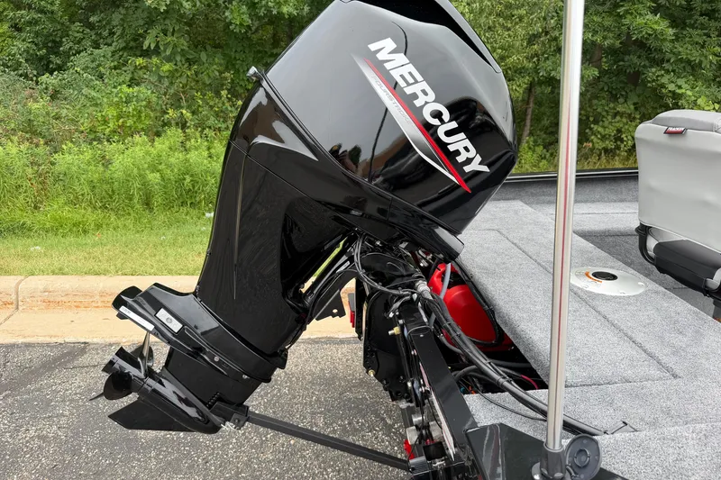 Slide: The Image of 2027 Tracker Super Guide V-16 SC with Mercury outboard motor, parked on pavement. - 17