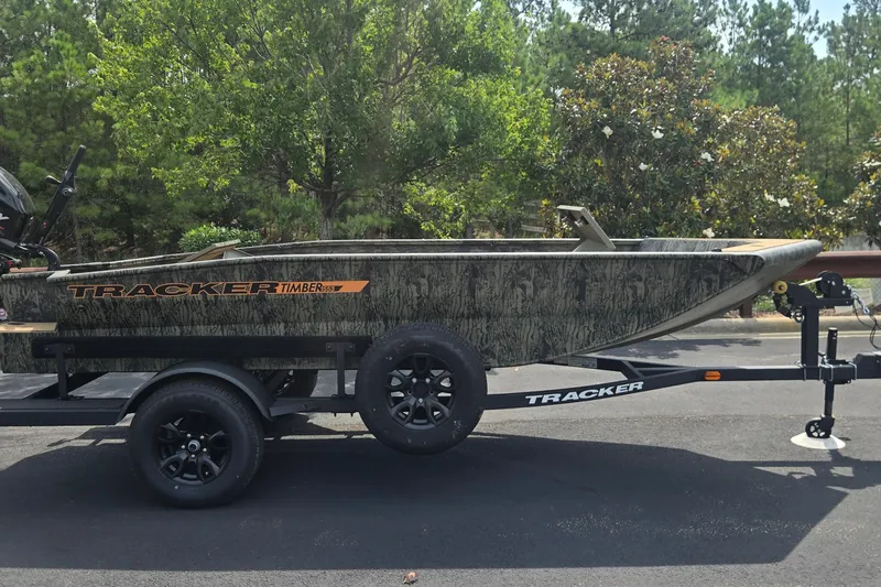 The Image of 2027 Tracker Grizzly 1553 Timber boat on trailer, parked outdoors. - 0