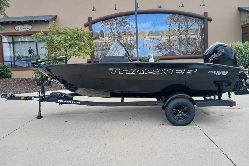 The Image of 2027 Tracker Pro Guide V-175 Combo boat on trailer, parked outdoors. - 0