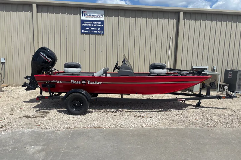 The Image of 2027 Tracker Bass Tracker Classic XL boat in red, parked outside a building. - 0