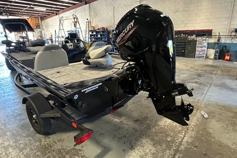 Slide: The Image of 2027 Tracker Pro Team 175 boat with Mercury outboard motor in a workshop setting. - 14