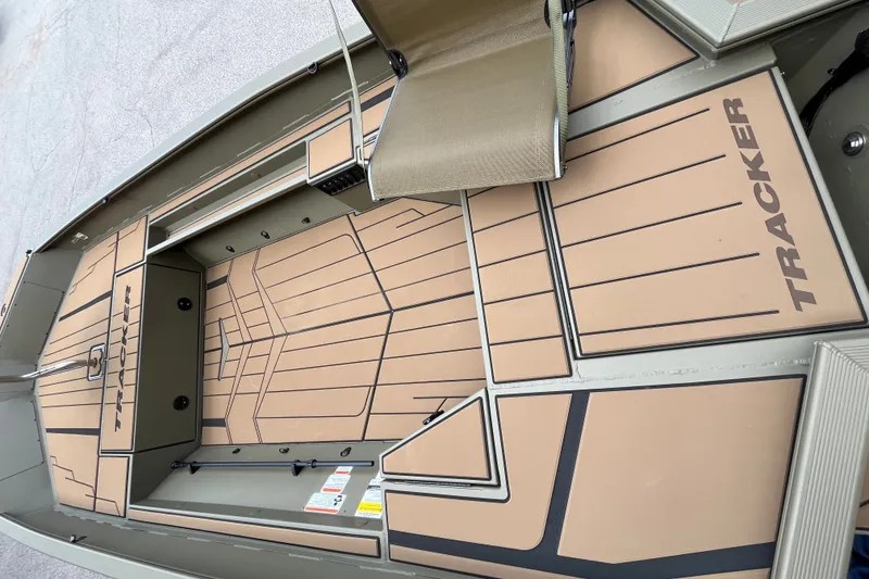 Slide: The Image of 2027 Tracker Grizzly 1553 Timber boat interior with tan flooring and seating. - 44