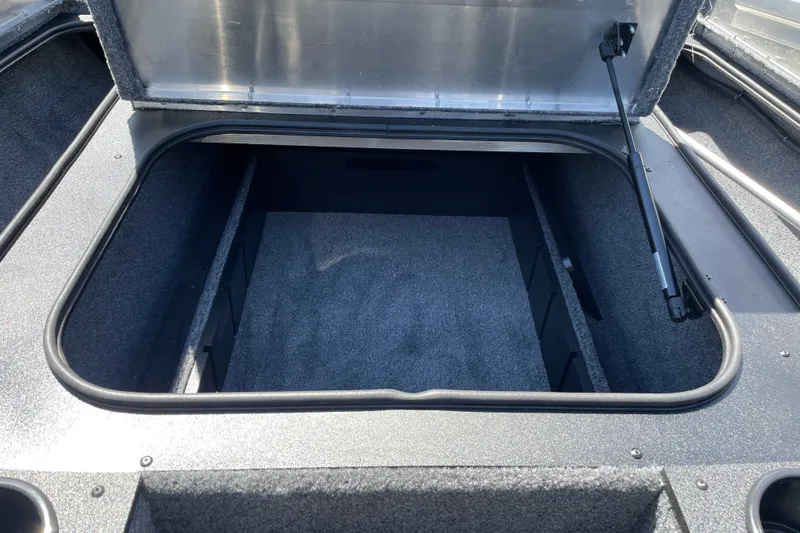 Slide: The Image of Open storage compartment of 2027 Tracker Pro Team 175 boat, featuring carpeted interior. - 19