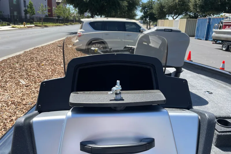 Slide: The Image of 2027 Tracker Pro Team 175 boat dashboard with windshield, parked on a street. - 13