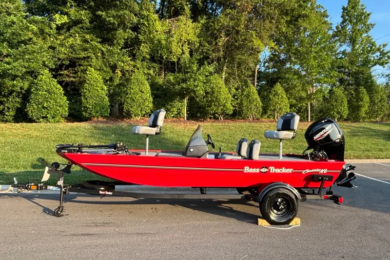The Image of 2027 Tracker Bass Tracker Classic XL boat on trailer, parked outdoors. - 0