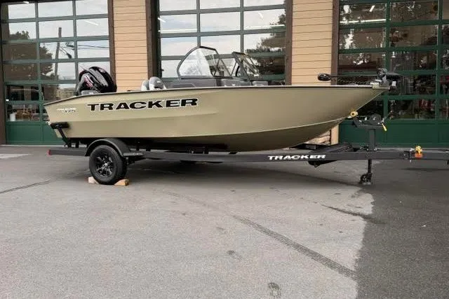 The Image of 2027 Tracker Pro Guide V-175 Combo boat on trailer, parked outdoors. - 0