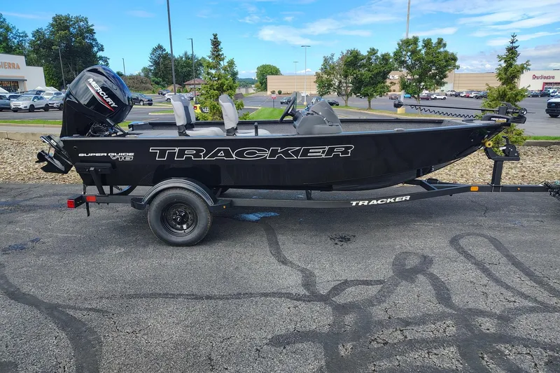 The Image of 2027 Tracker Super Guide V-16 SC boat on trailer in parking lot. - 0
