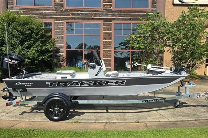 The Image of 2027 Tracker Bass Tracker Classic CC boat on trailer, parked outdoors. - 0