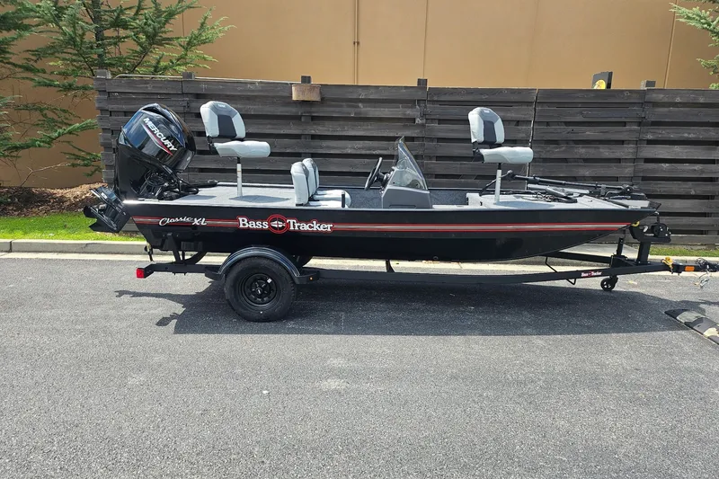 The Image of 2027 Tracker Bass Tracker Classic XL fishing boat on trailer, parked outdoors. - 0