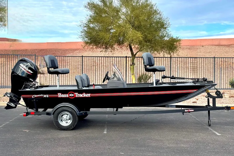 The Image of 2027 Tracker Bass Tracker Classic XL boat on trailer, parked outdoors. - 0
