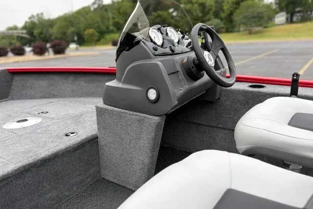 Slide: The Image of Interior of 2027 Tracker Super Guide V-16 SC boat with steering console and seating. - 21