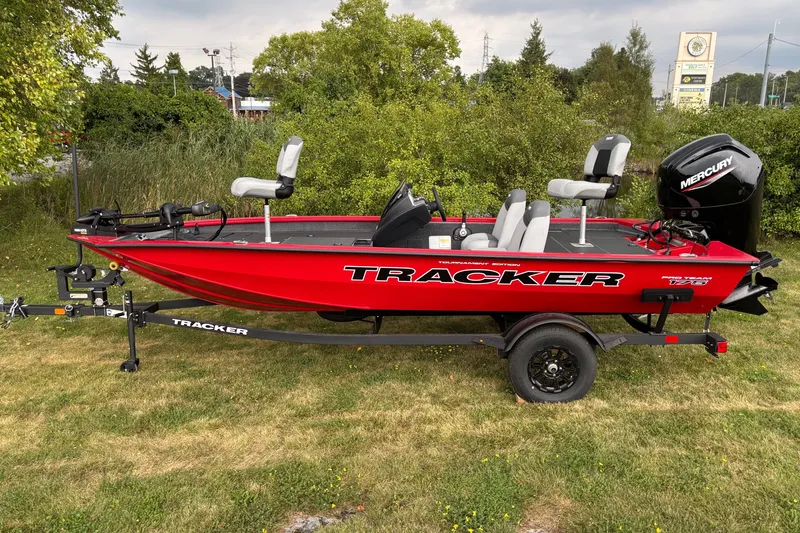 The Image of Red 2027 Tracker Pro Team 175 boat on trailer, featuring Mercury outboard motor. - 0