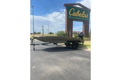 The Image of 2027 Tracker Grizzly 1756 T Marsh boat on trailer outside Cabela's store. - 0