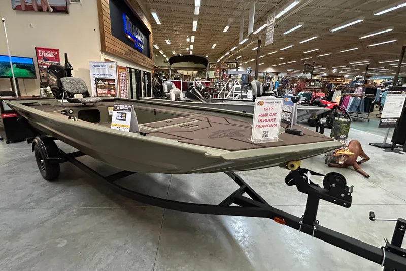 The Image of 2027 Tracker Grizzly 1654 T Sportsman boat displayed in a showroom with financing options. - 0
