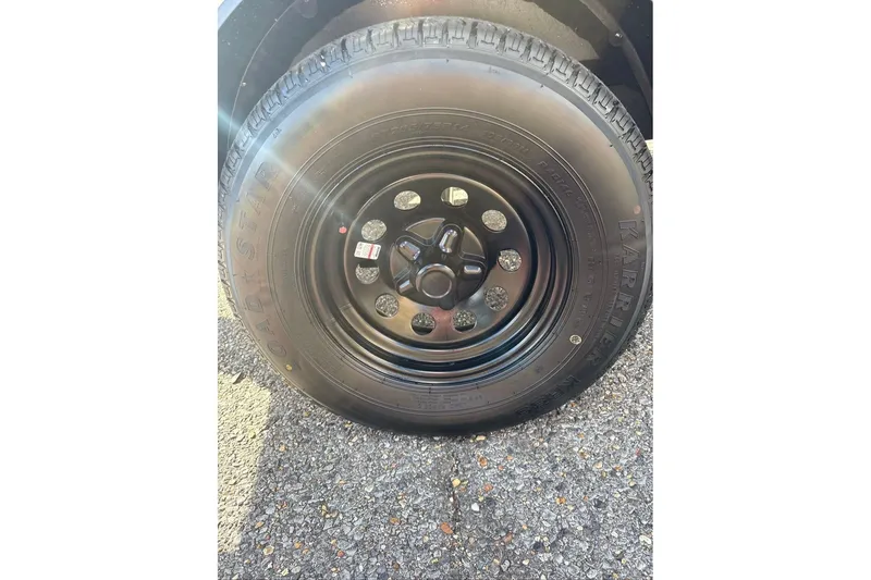 Slide: The Image of 2027 Nitro Z18 XL Pro tire on asphalt, showcasing black steel wheel and tread pattern. - 2